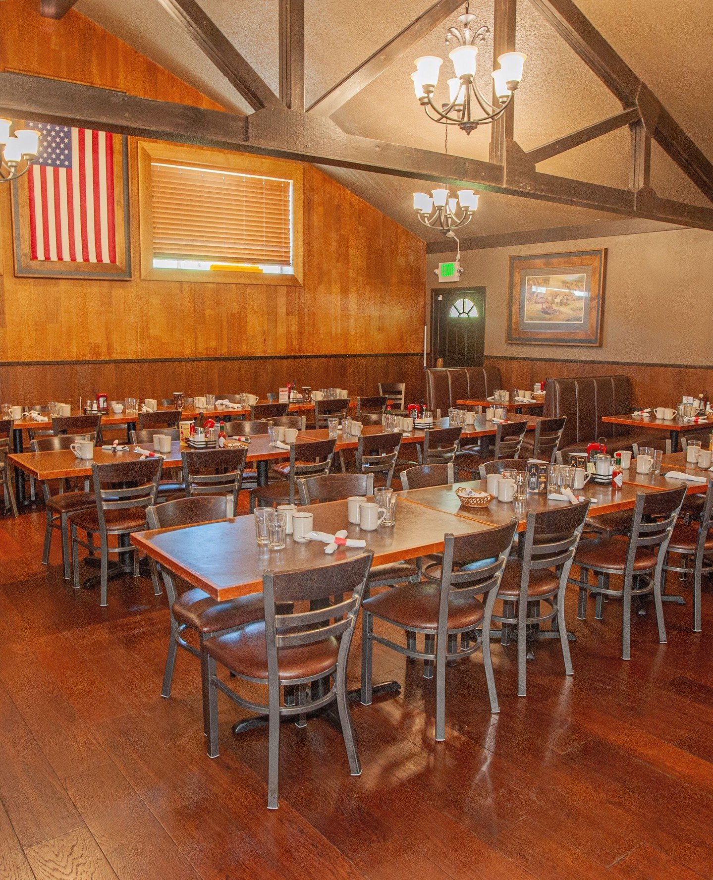 Burs dining room with wood walls and tables set for guests