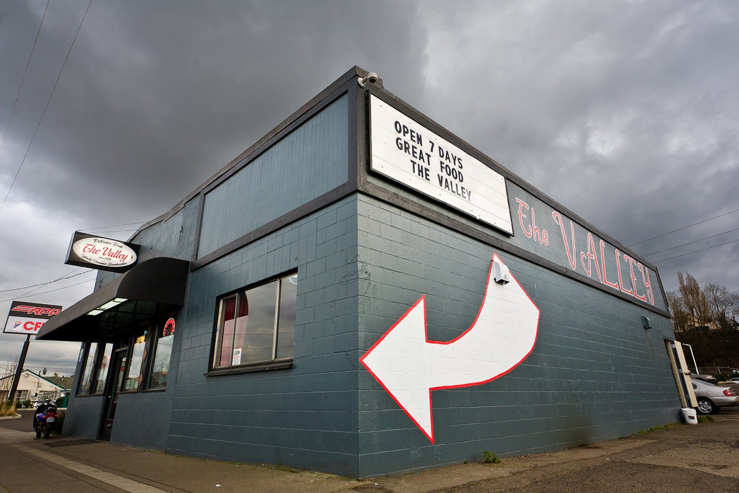 The Valley exterior patio seating and Valley Pub signs on Puyallup Ave